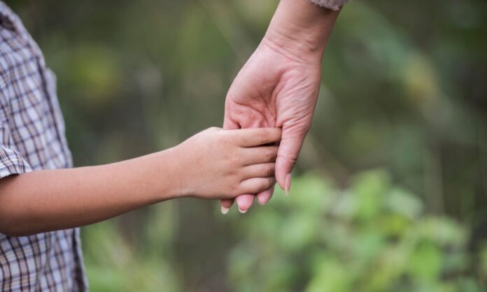 1698404-bc3ee6d0-close-up-happy-mum-son-holding-hand-park-family-concept.jpg