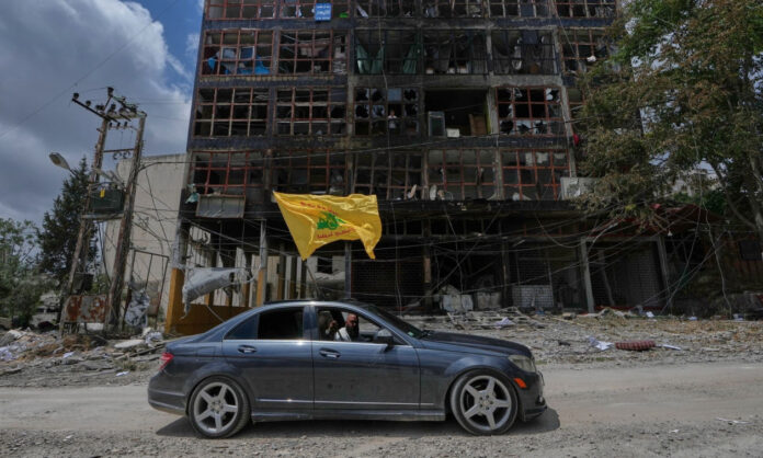 1745458-2c5dc964-man-with-a-hezbollah-flag.jpg